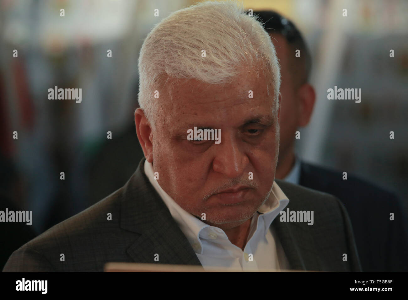 Baghdad, Iraq. 24th Apr, 2019. Popular Mobilization Forces (PMF) chairman Falih Alfayyadh attends a conference organized by the predominantly Shia Muslim PMF to honour Iranian fighters who died fighting the so-called Islamic State (IS) terror group. Credit: Ameer Al Mohammedaw/dpa/Alamy Live News Stock Photo