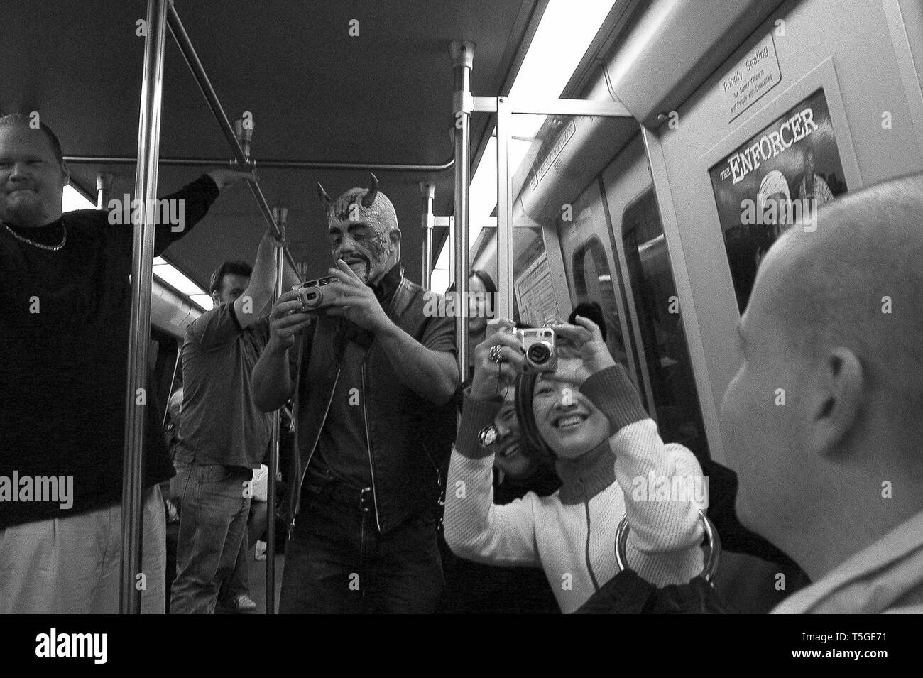 Washington, DC, USA. 31st Oct, 2003. People take photos of other people wearing costumes for Halloween on the Metro in Washington, DC, October 31, 2003. Credit: Bill Putnam/ZUMA Wire/Alamy Live News Stock Photo