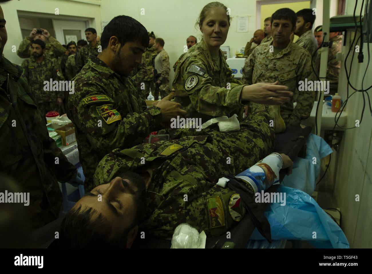 Camp Shorabak, Helmand, Afghanistan. 29th Dec, 2012. U.S. Air Force Capt. Andrea Hickman, with the Medical Training Advising Group, Regional Support Command-Southwest, helps treat a during a mass casualty exercise at Camp Shorabak, Helmand province, Afghanistan, Dec. 29, 2012. The exercise was done to test the capabilities of the 215th Corps' clinic; ANA physician and combat medic capabilties from point of injury to trauma triage care; and, evaulate transition strategies. Doctors from RSC-SW and the 215th Corps advisory team built the exercise around a car bomb exploding at a checkpoi Stock Photo