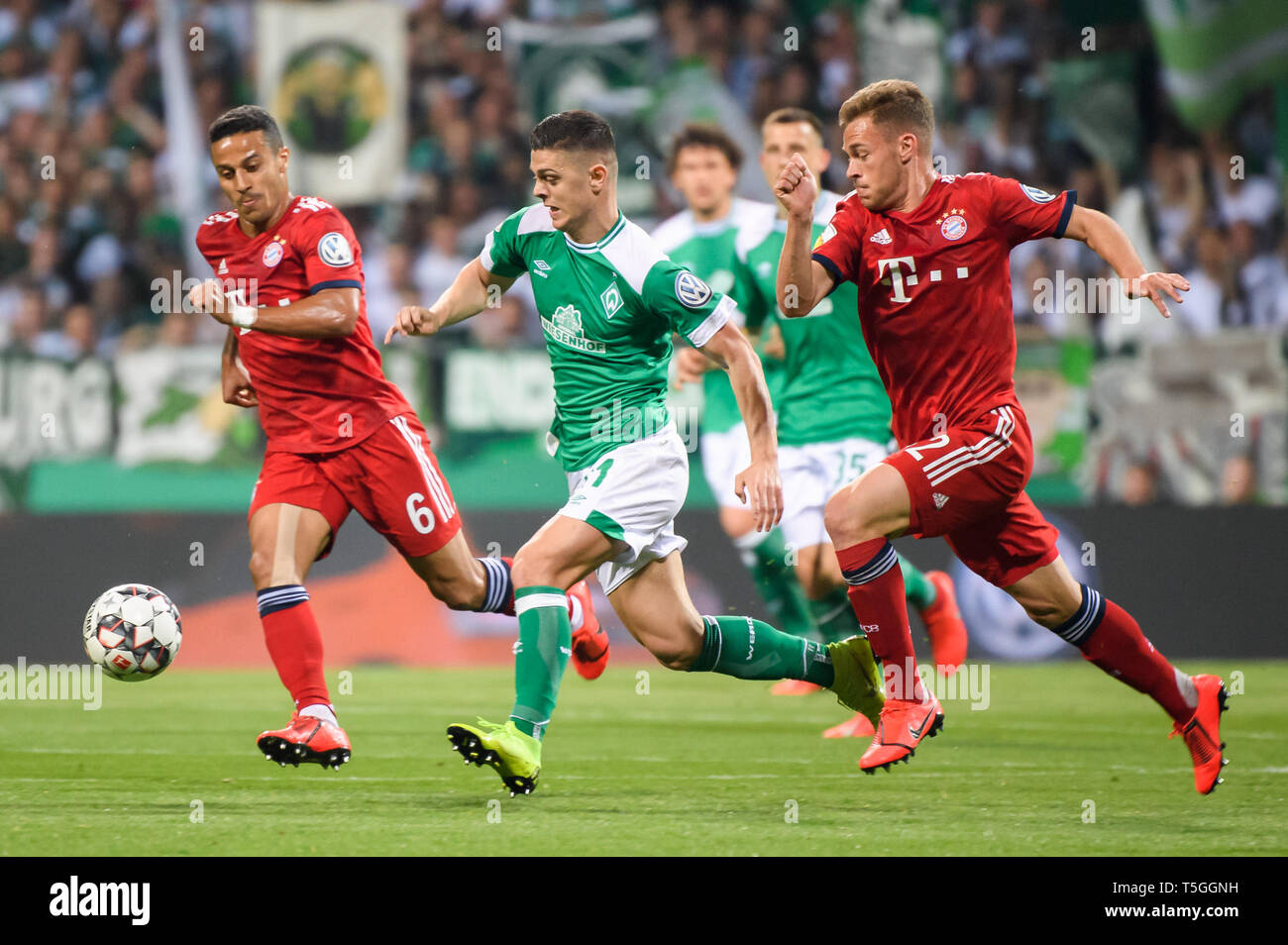 Bremen, Germany. 24th Apr, 2019. Bremen's Milot Rashica (2nd L) breaks through the defense from Bayern Munich's Joshua Kimmich (1st R) and Thiago (1st L) during a semifinal match of German Cup between SV Werder Bremen and FC Bayern Munich in Bremen, Germany, on April 24, 2019. Bremen lost 2-3. Credit: Kevin Voigt/Xinhua/Alamy Live News Stock Photo