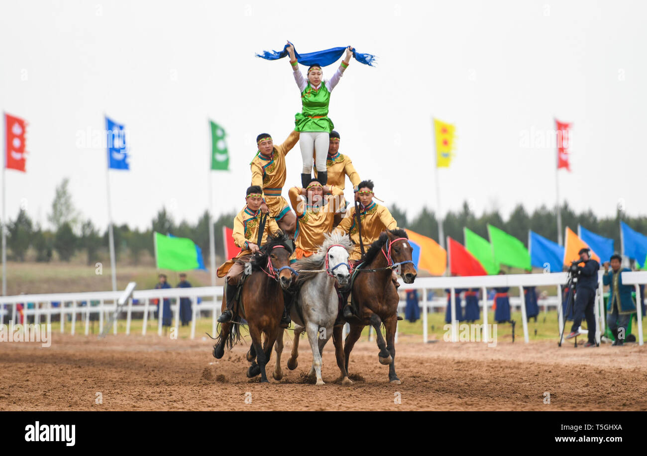 Inner Mongolia, China's Inner Mongolia Autonomous Region. 24th Apr, 2019. People make a human pyramid on horses at the Genghis Khan Chagan Suluk Nadam Fair in Ejin Horo Banner of Ordos City, north China's Inner Mongolia Autonomous Region, April 24, 2019. The two-day fair kicked off on Wednesday, including a variety of traditional activities. Credit: Peng Yuan/Xinhua/Alamy Live News Stock Photo