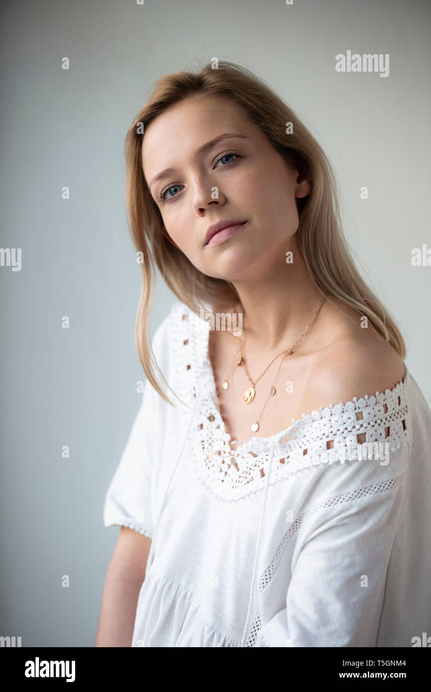 Portrait of young woman, wearing white dress Stock Photo