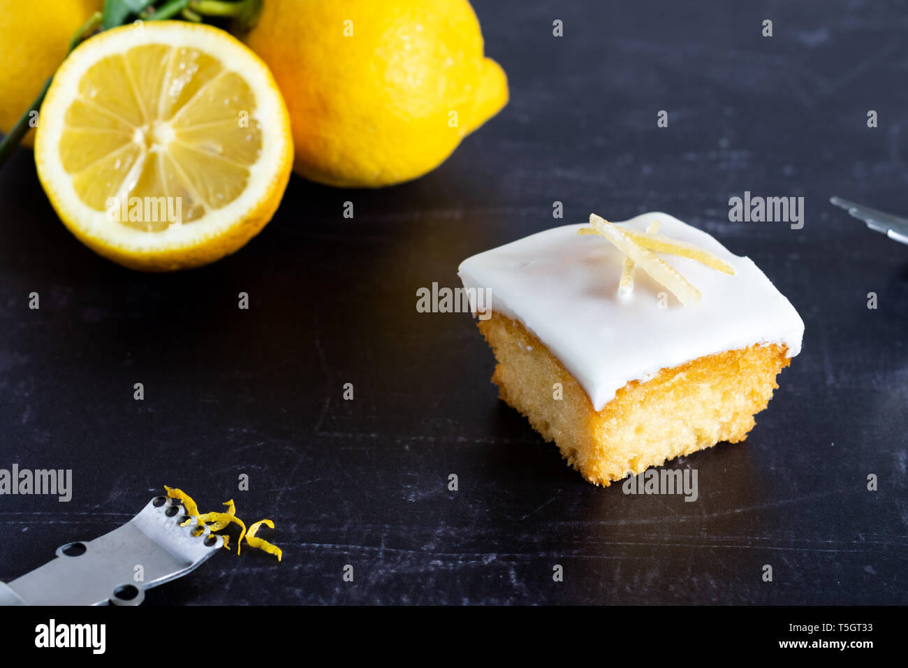 An individual lemon cake on a dark background Stock Photo