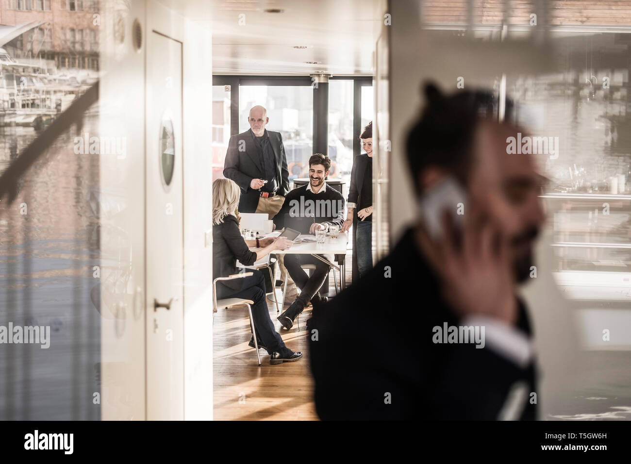 Business people work relaxed together in bright office Stock Photo