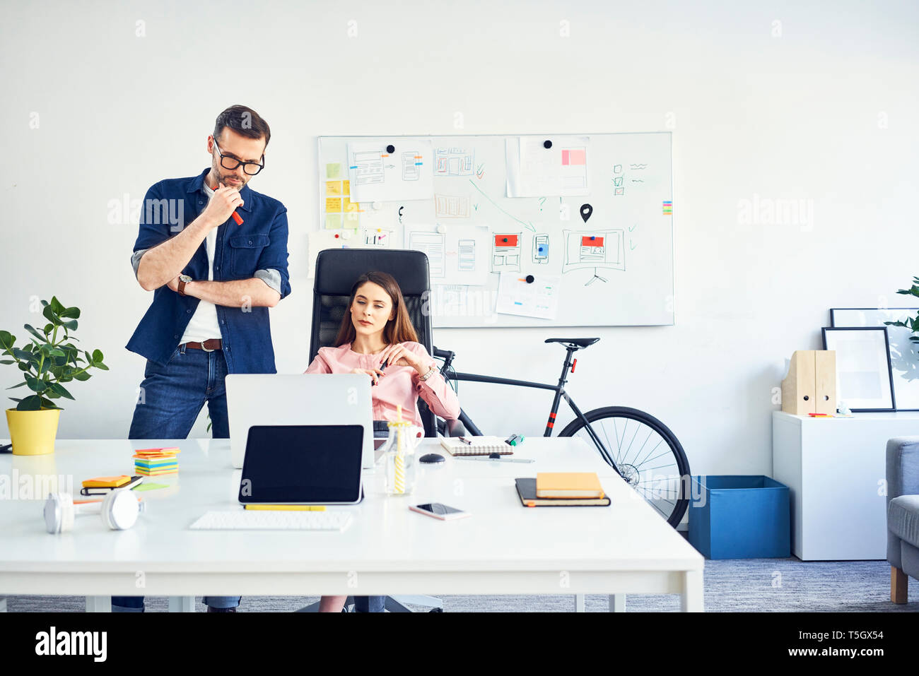 Two colleagues working together on laptop in office Stock Photo