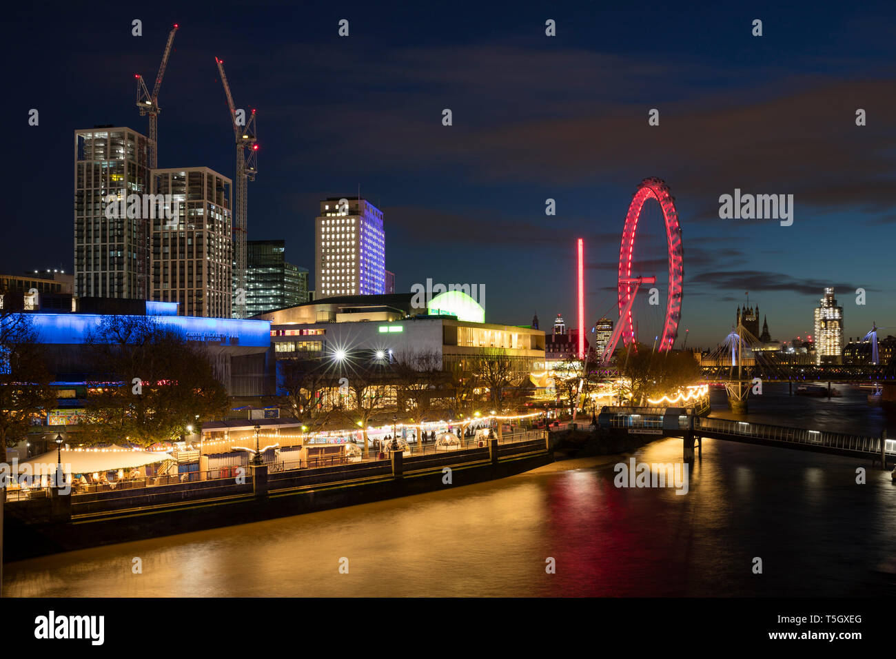 United Kingdom, England, London, Queen Elizabeth Hall, Royal Festival Hall and London Eye at River Thames at night Stock Photo