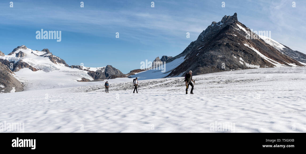 Greenland, Sermersooq, Kulusuk, Schweizerland Alps, group of people walking in snow Stock Photo