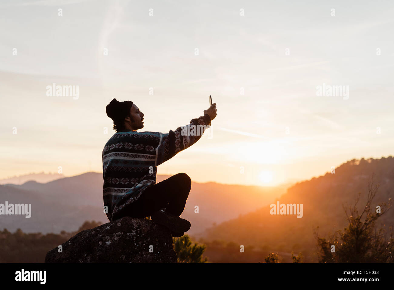 Young man looking over Parc Natural Sant Llorenç del Munt i l Obach, Barcelona, Spain Stock Photo