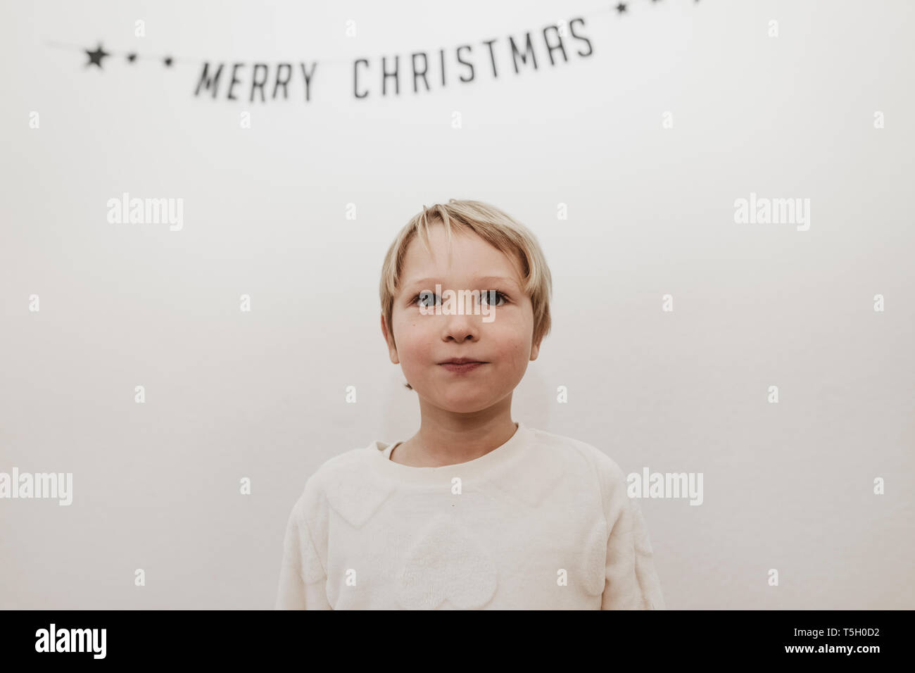 Blonde boy looking forward to Christmas Stock Photo