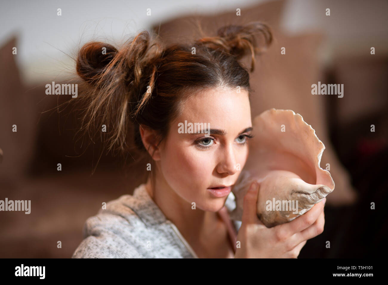 Portrait of young woman with big shell Stock Photo
