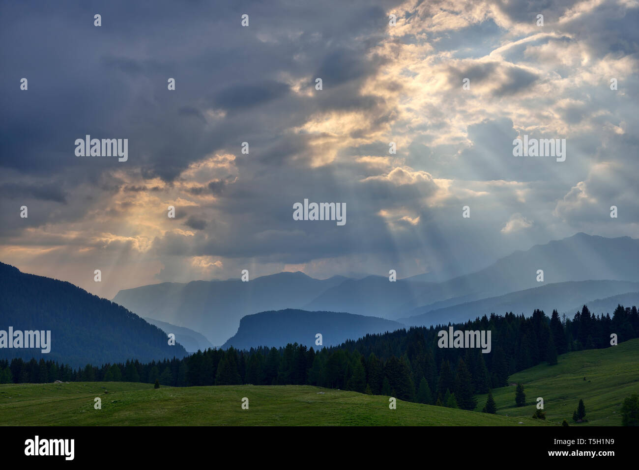 Rays of light break through clouds, Dolomites, Italy Stock Photo
