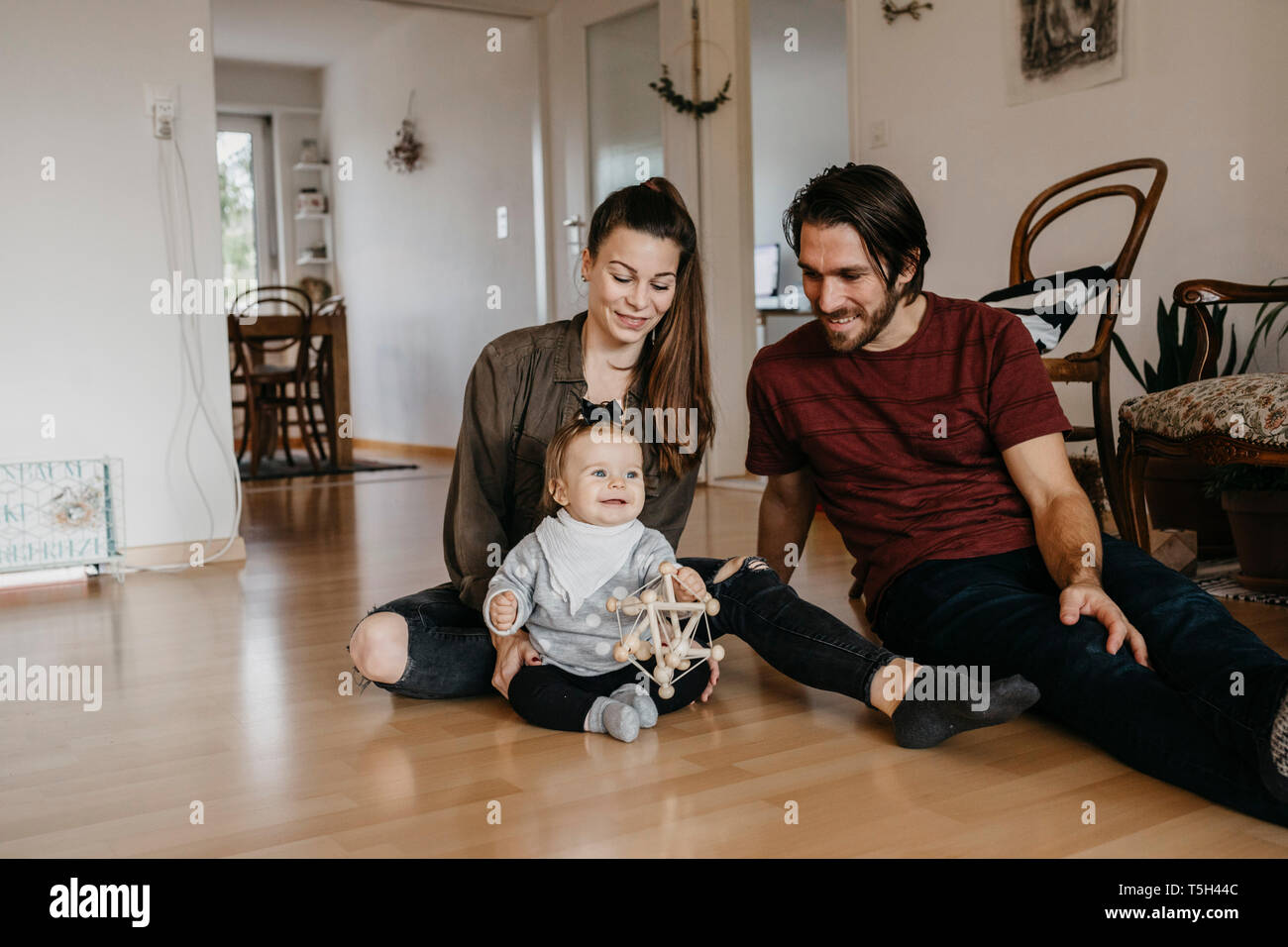 Happy girl sitting on floor hi-res stock photography and images - Alamy