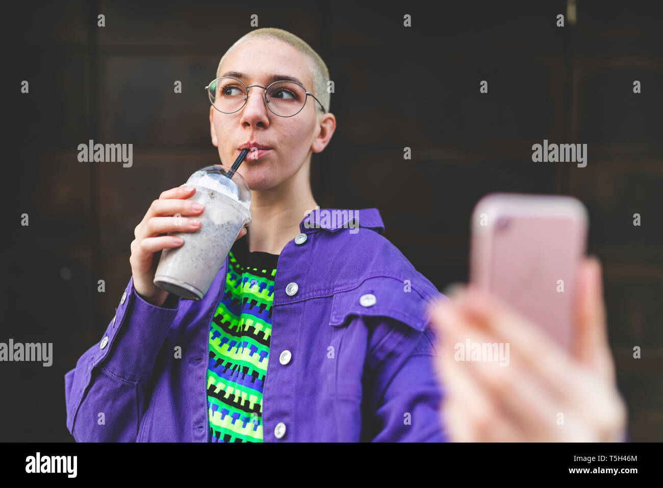 Young woman in the city enjoying a frappe Stock Photo