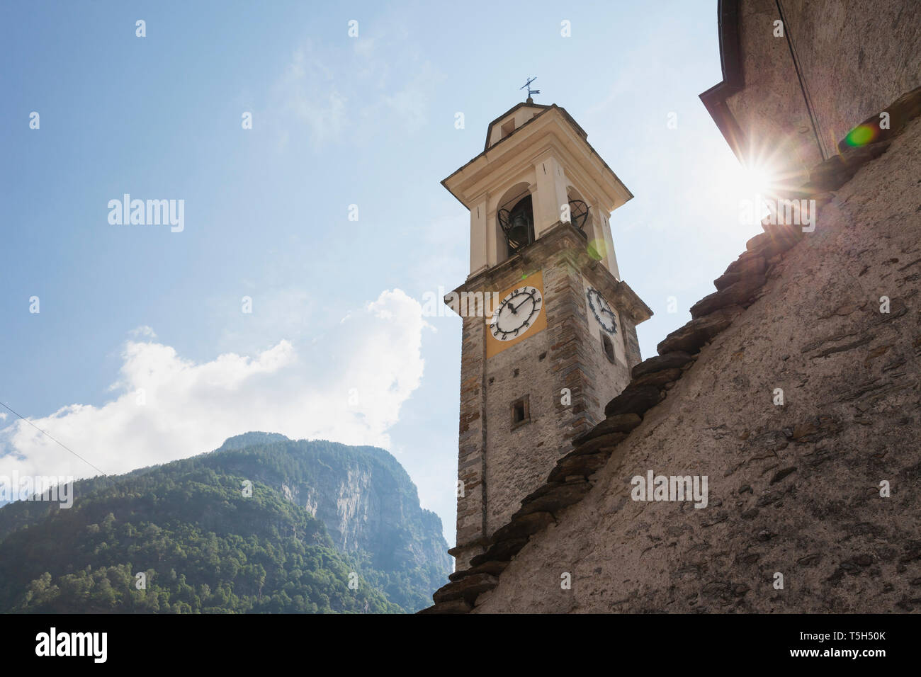 Switzerland, Ticino, Sonogno, historic village church, clock tower Stock Photo
