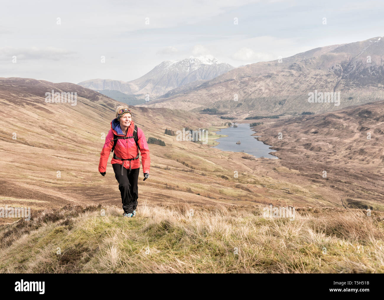 UK, Scotland, Onich, Beinn Na Gucaig, woman hiking in mountain scenery Stock Photo