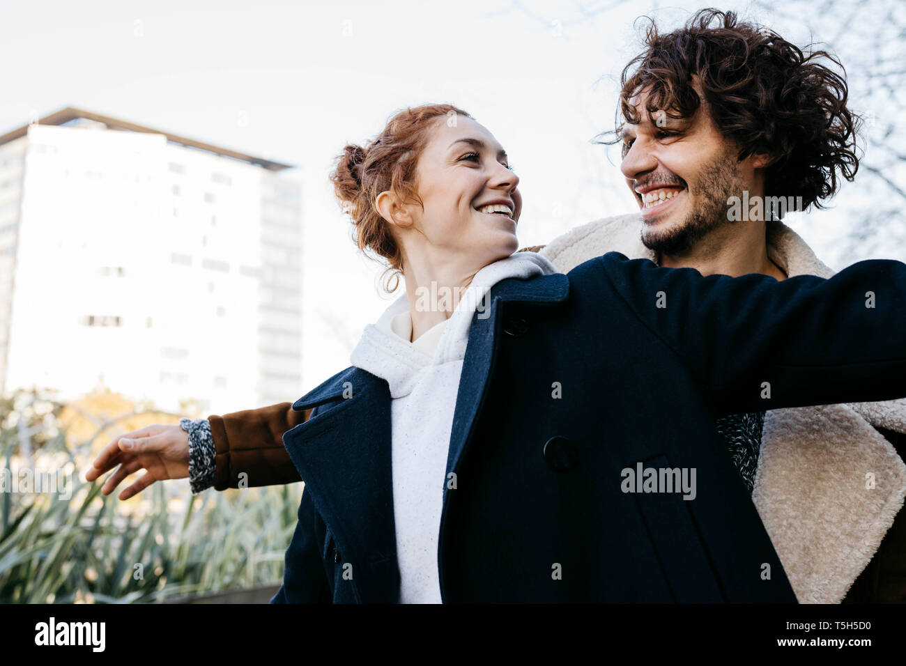 Happy couple in the city facing each other Stock Photo
