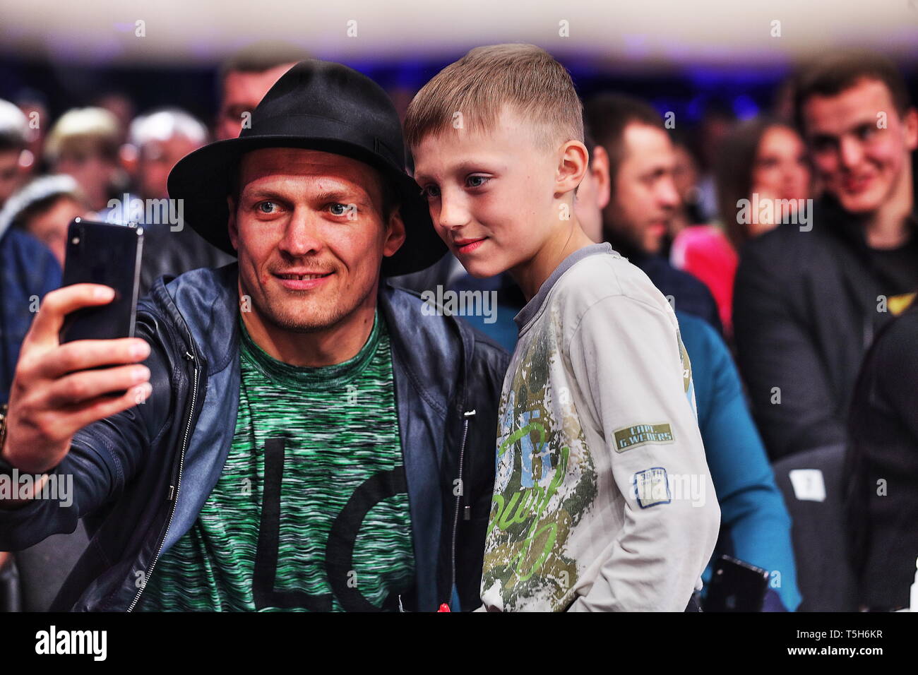 London 2012 Olympic Champion and pro boxing Absolute World Cruiser champ Alexander Usyk maks selfie for a stranger kid at ringside in Kiev sportpalace Stock Photo