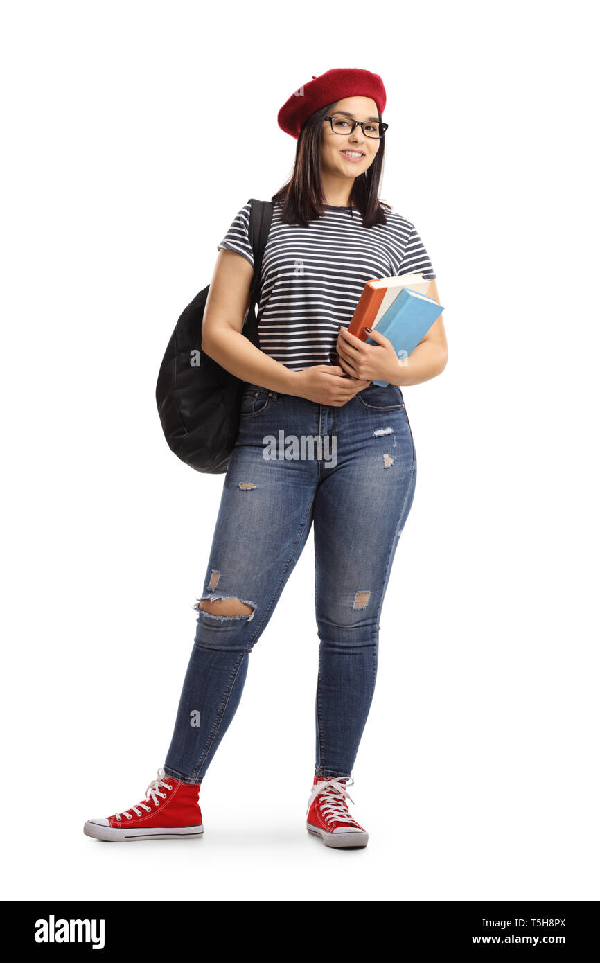 Full length portrait of a female student posing with books in her hands ...