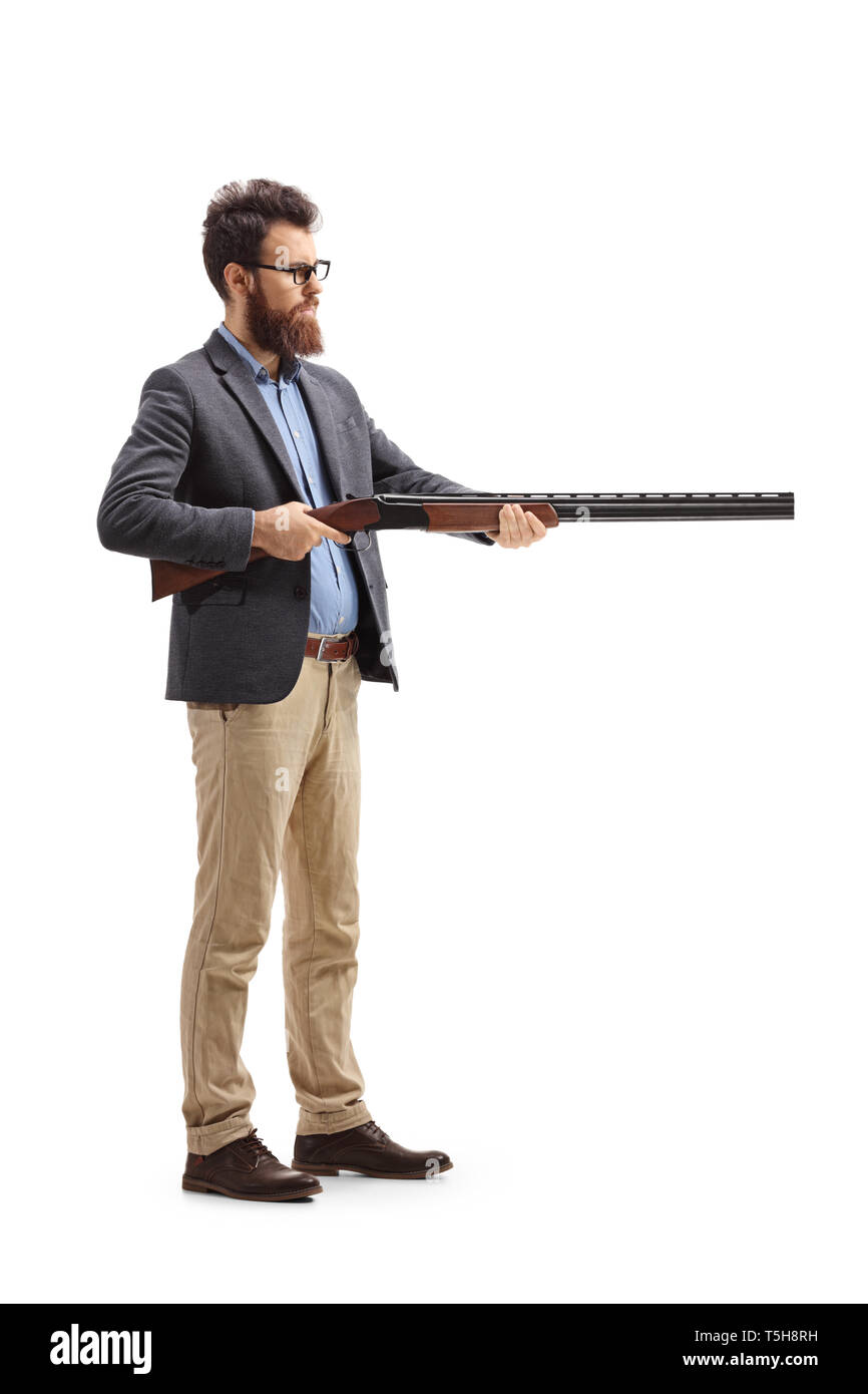 Full length shot of a man aiming with a shotgun isolated on white background Stock Photo