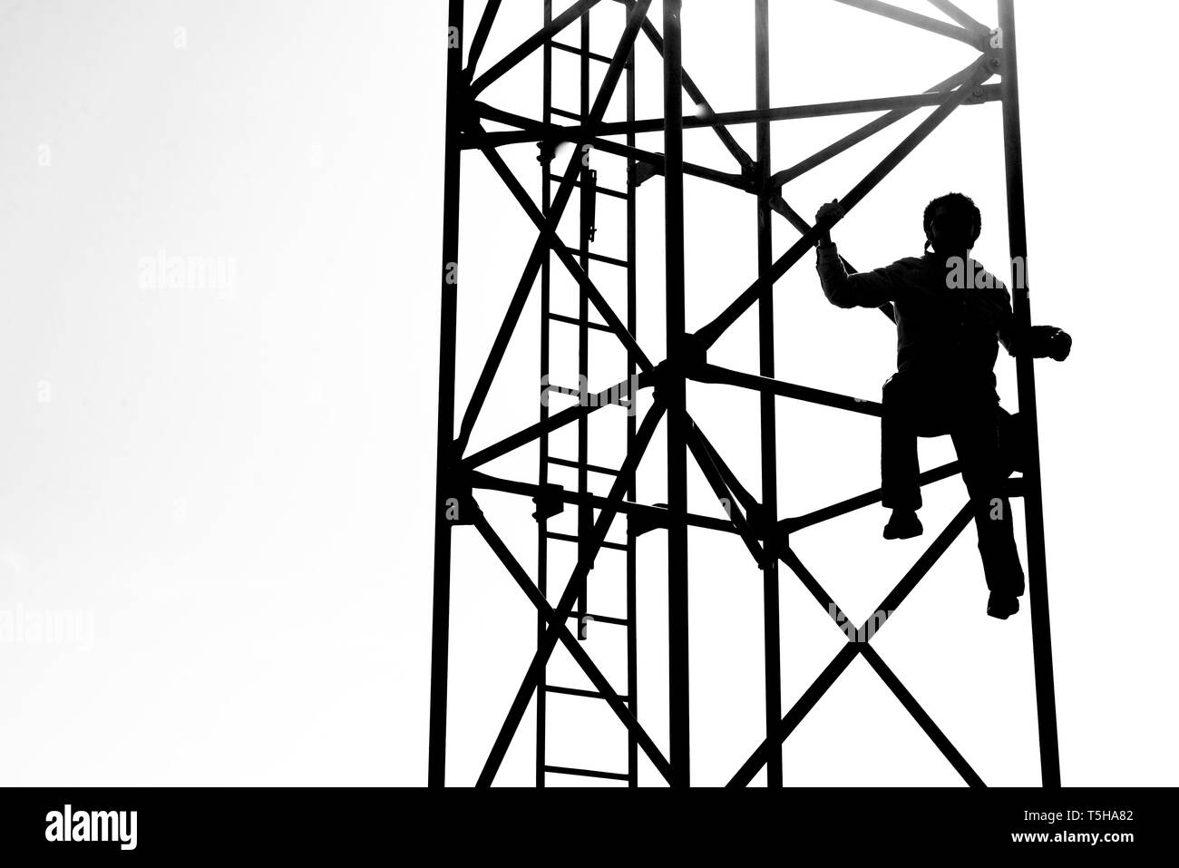 Silhouette of a Boy on a Radio Tower Stock Photo