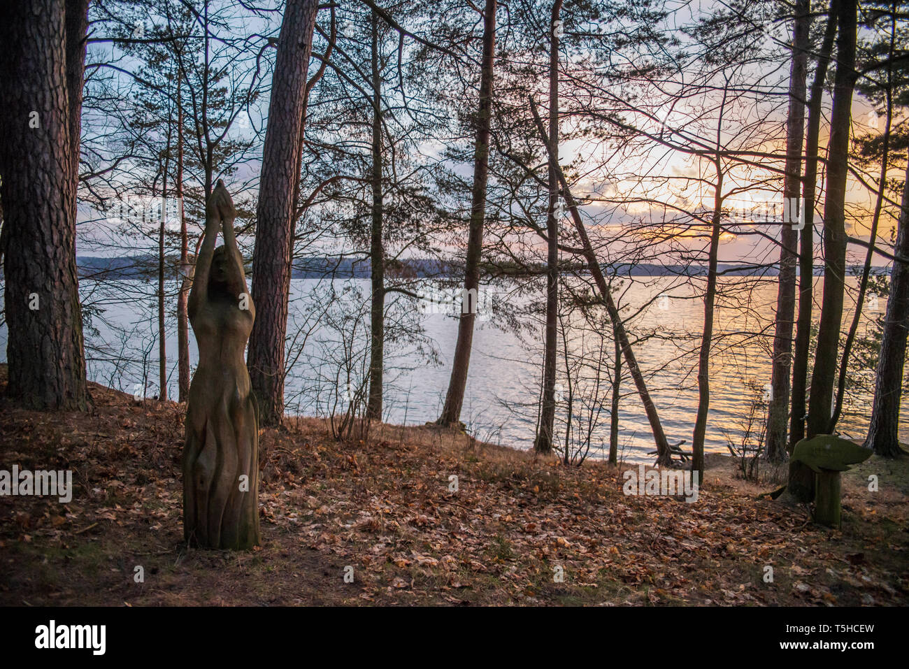 Wooden sculpture on Vištytis Lake, sunset Stock Photo