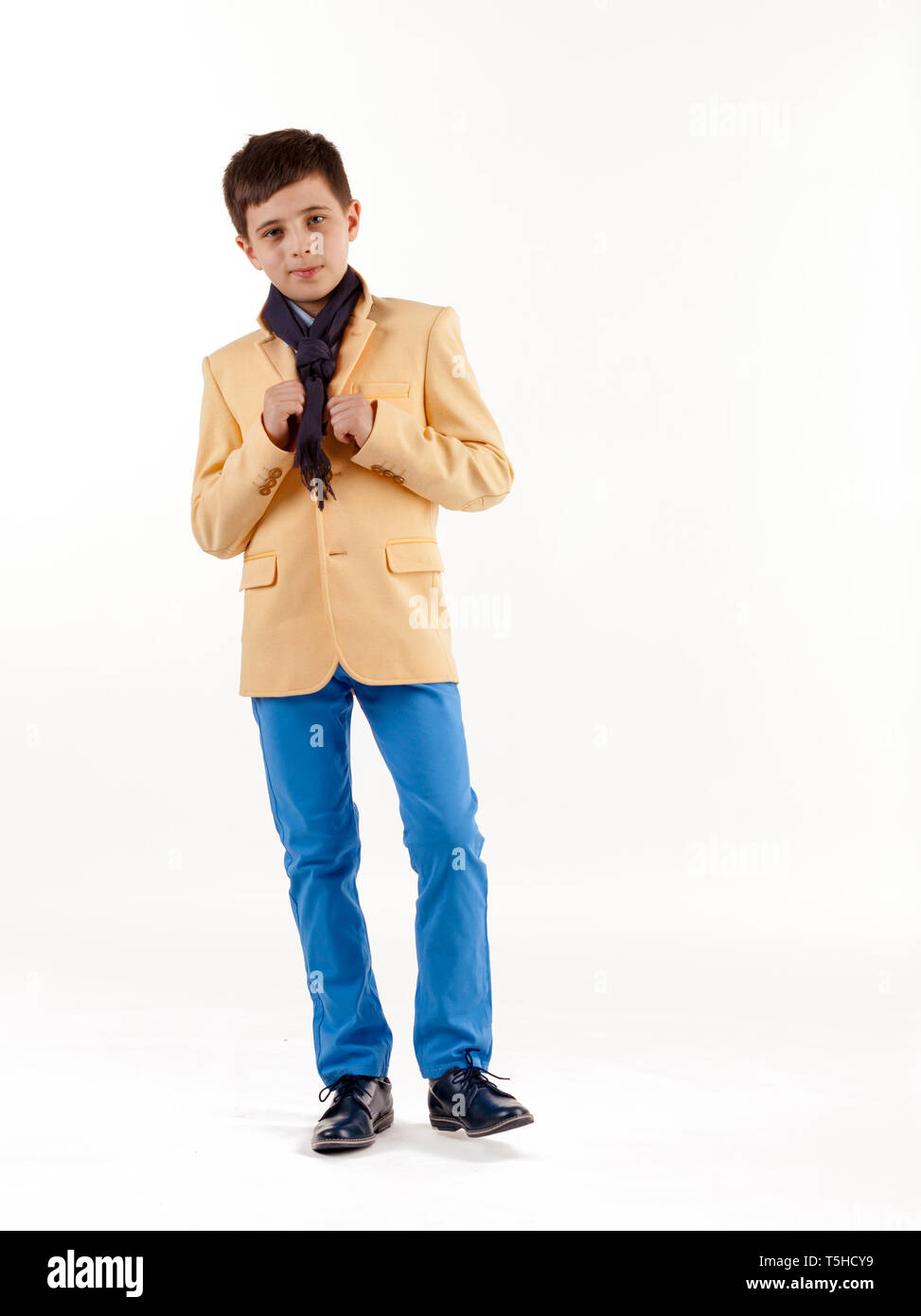 Kids fashion. Boy in an elegant jacket and pants isolated on white