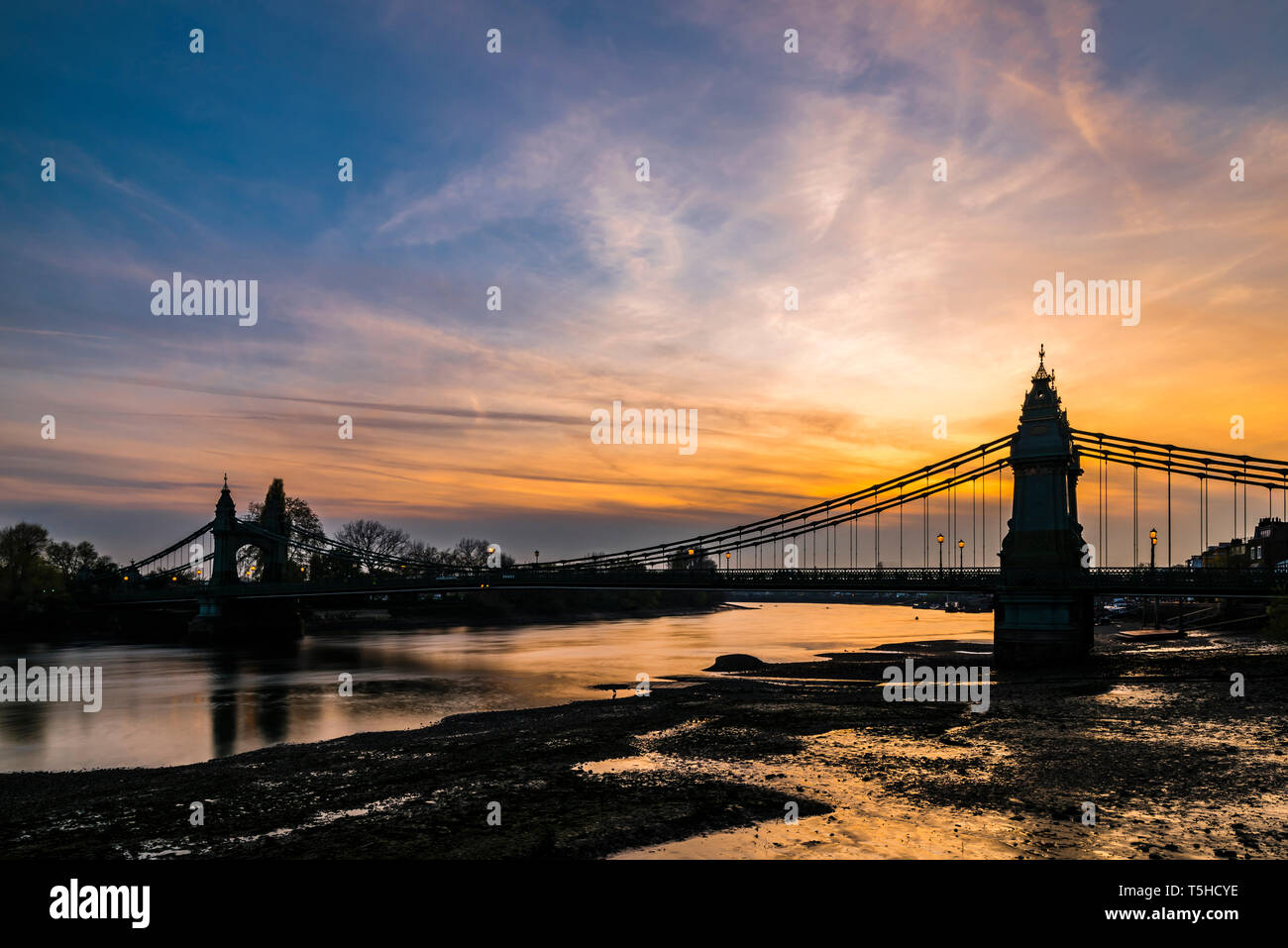 Orange skies at sunset over Hammersmith Bridge, London, UK Stock Photo