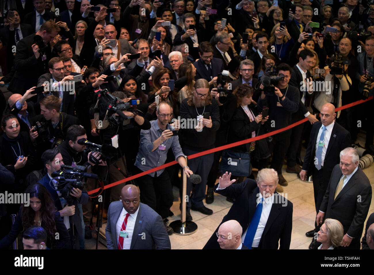 Massive crowd inside the Congress Center in Davos as the US President Donald J. Trump arrives to the World Economic Forum. former Secretary of State Rex Tillerson walks behind him. Stock Photo