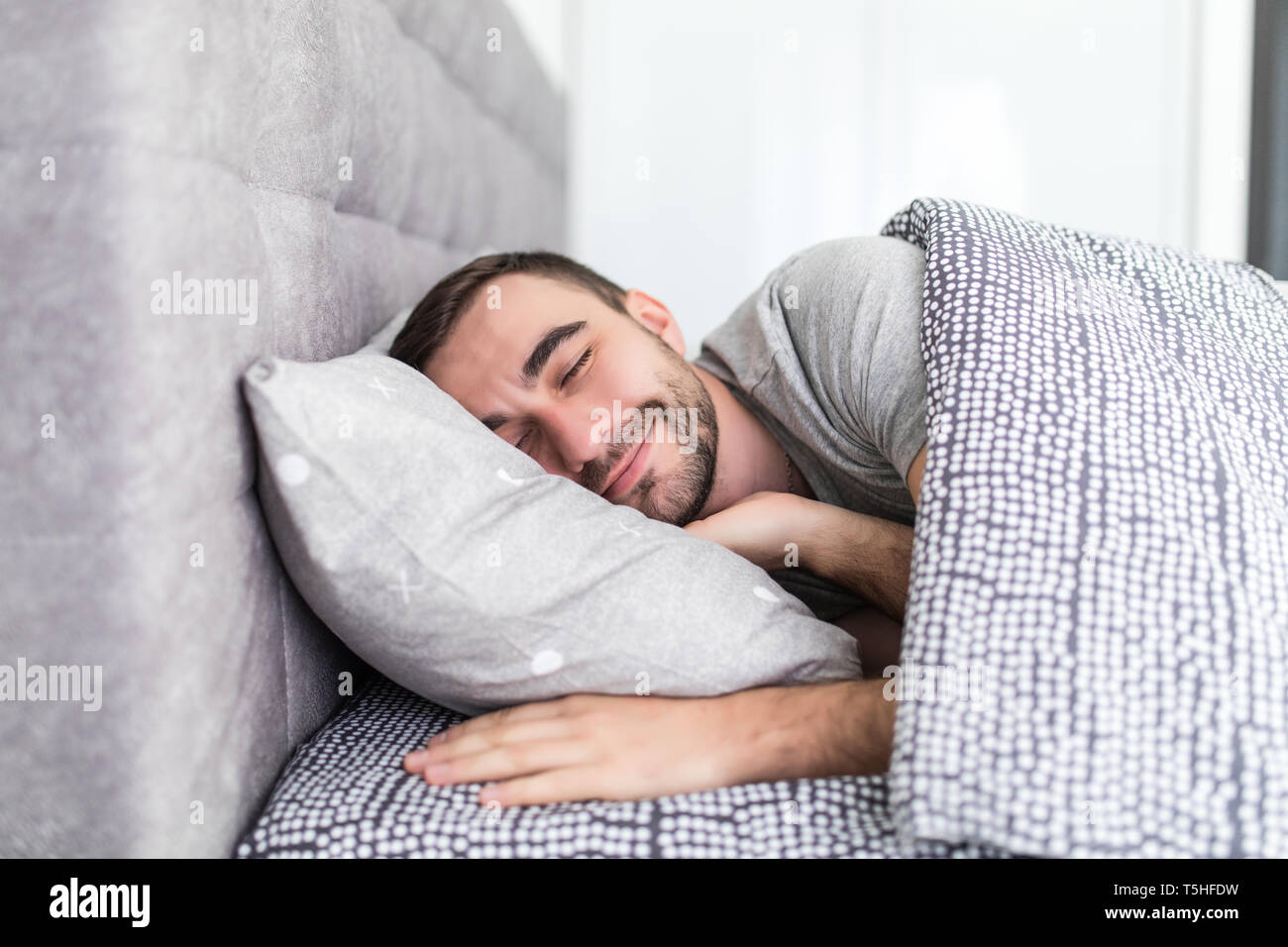 Handsome man sleeping in bed hires stock photography and images Alamy