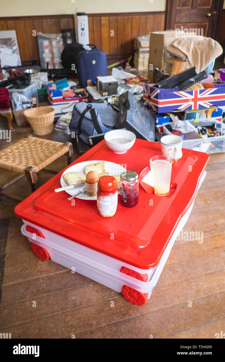 Packing,boxes,moving,house,home,furniture,room,clearance,possessions,belongings,house,removal,chaos,chaotic,stress,breakfast,on,boxes,box,Wales,UK Stock Photo