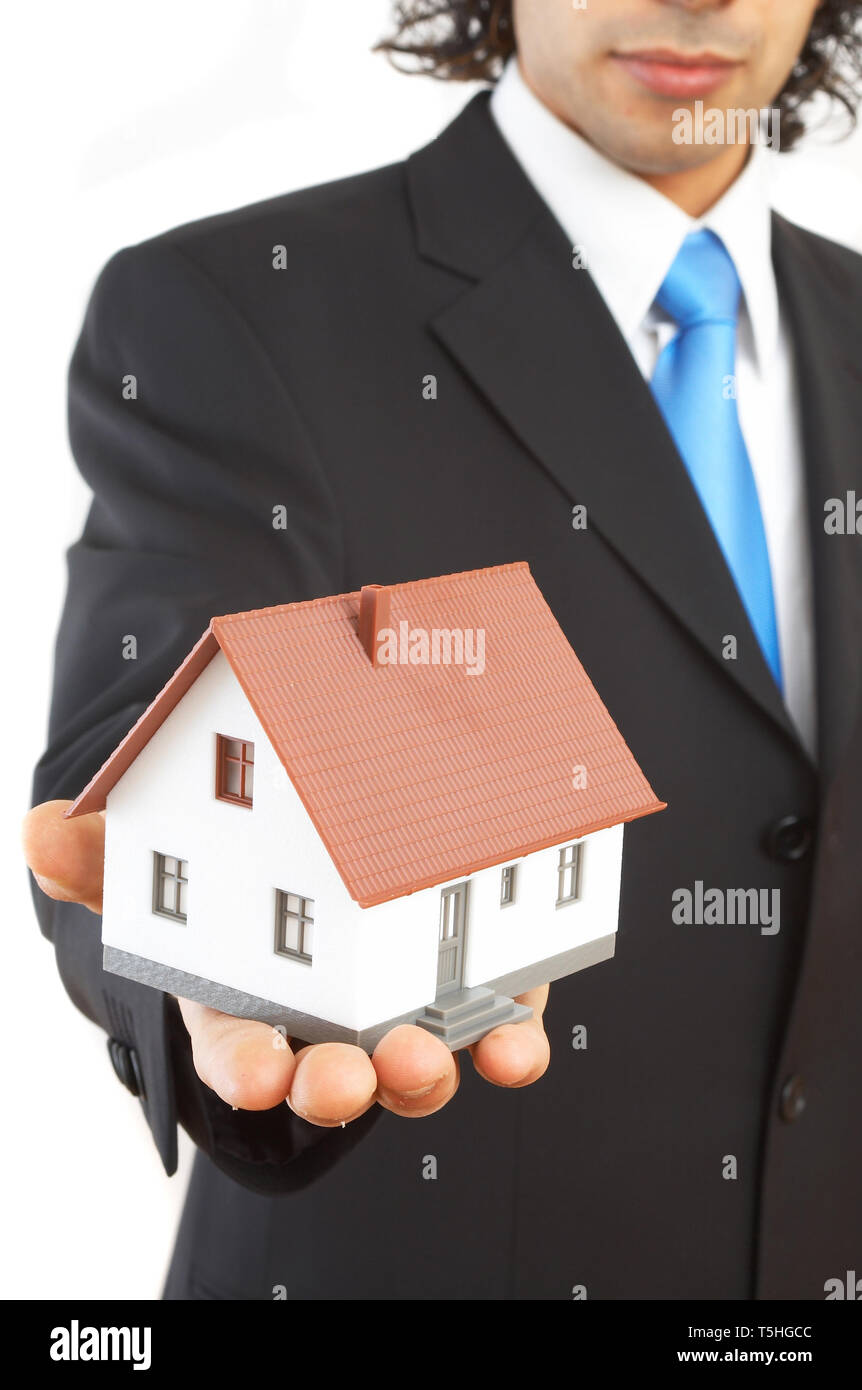 real estate concept with a mini house Stock Photo - Alamy