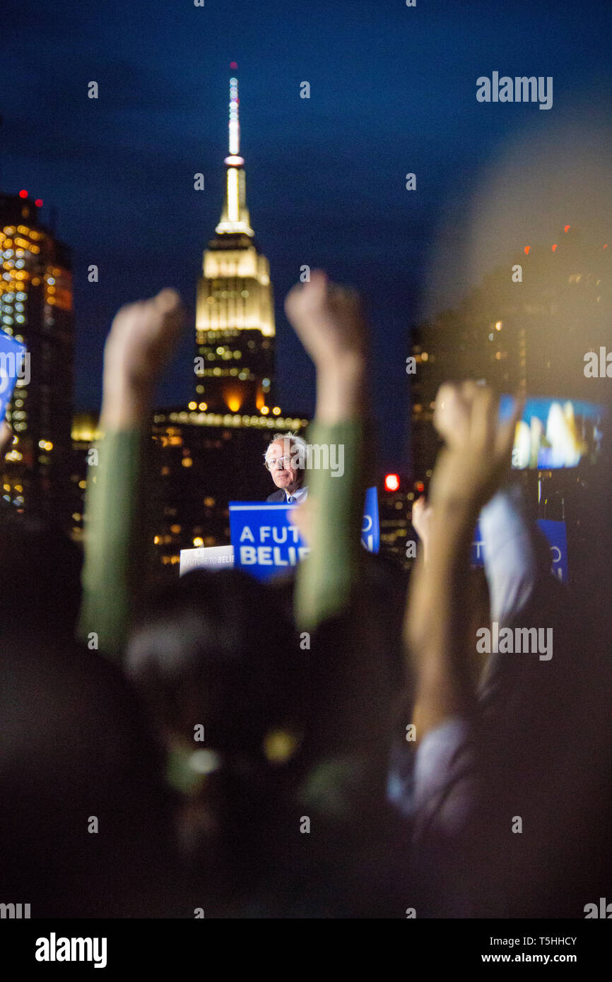 On the eve before the New York State primaries election in 2016, Presidential hopeful Senator Bernie Sanders (D-Vt) holds a last rally in the Hunters Point South Park in Queens. His campaign slogan 'A future to believe in' is on all the posters, and with the Manhattan skyline as a backdrop with the Empire State Building clearly visible. Stock Photo