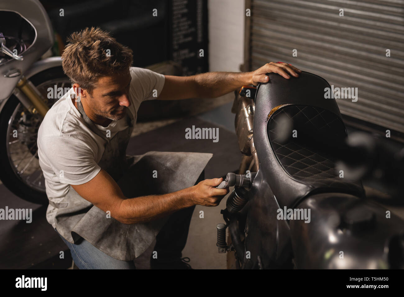 Bike mechanic checking bike with ratchet wrench Stock Photo