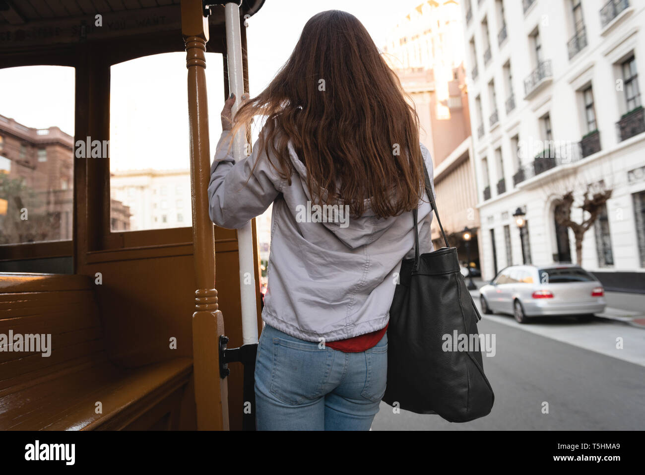 Happy woman hanging outside the moving vehicle Stock Photo
