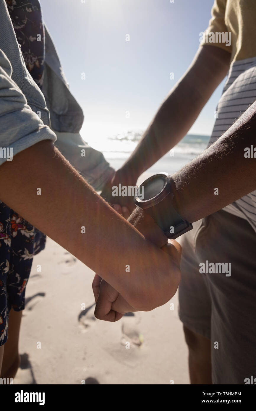 Couple holding hands on beach Stock Photo