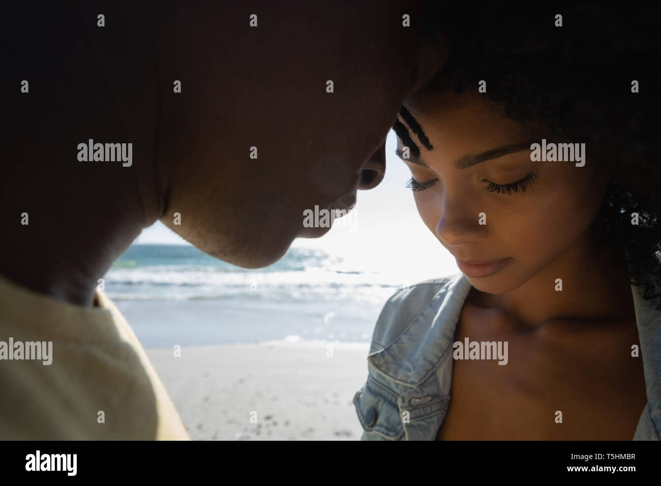 Romantic couple standing at beach Stock Photo