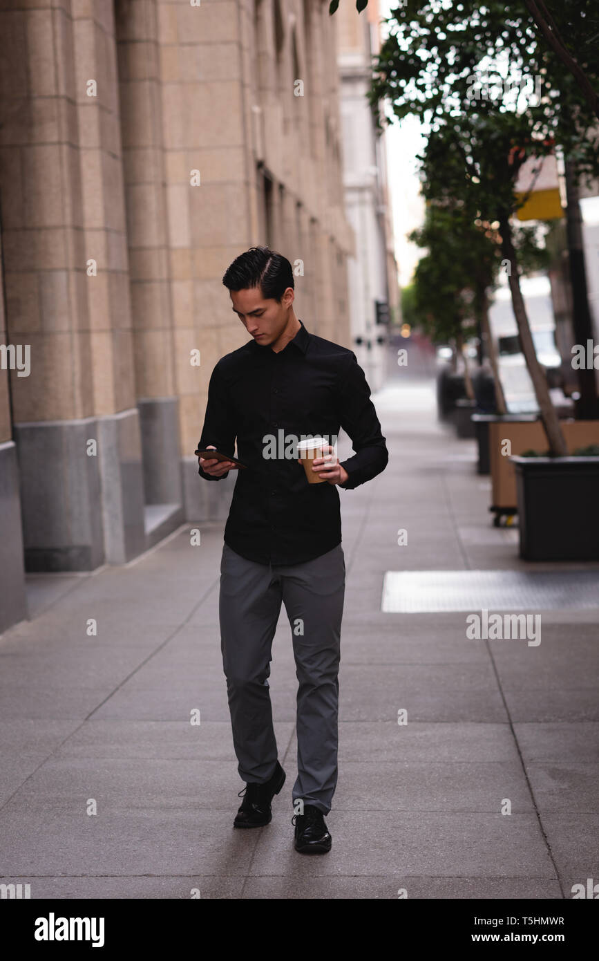 Young asian man walking street hi-res stock photography and images - Alamy
