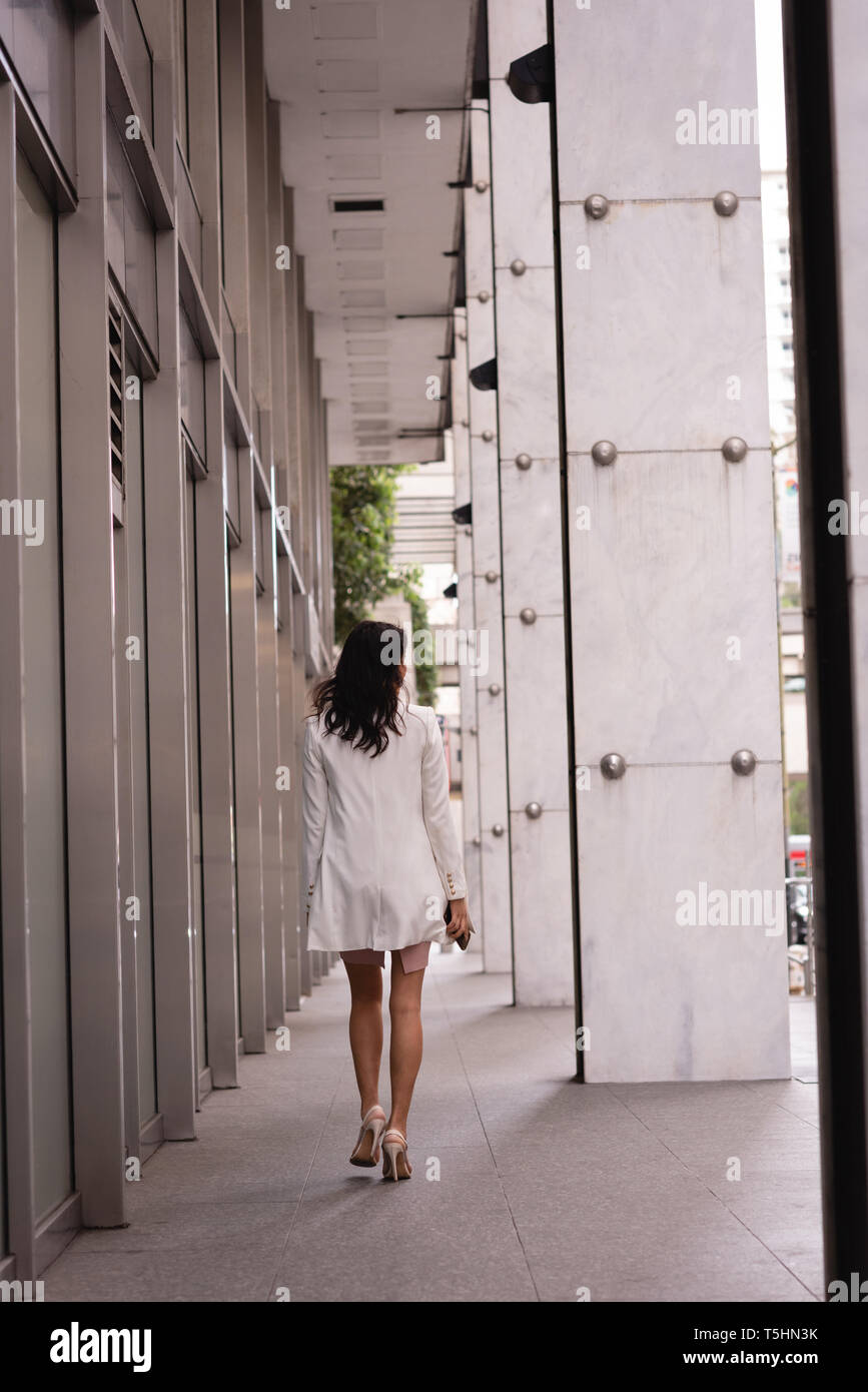 Beautiful woman walking at corridor Stock Photo