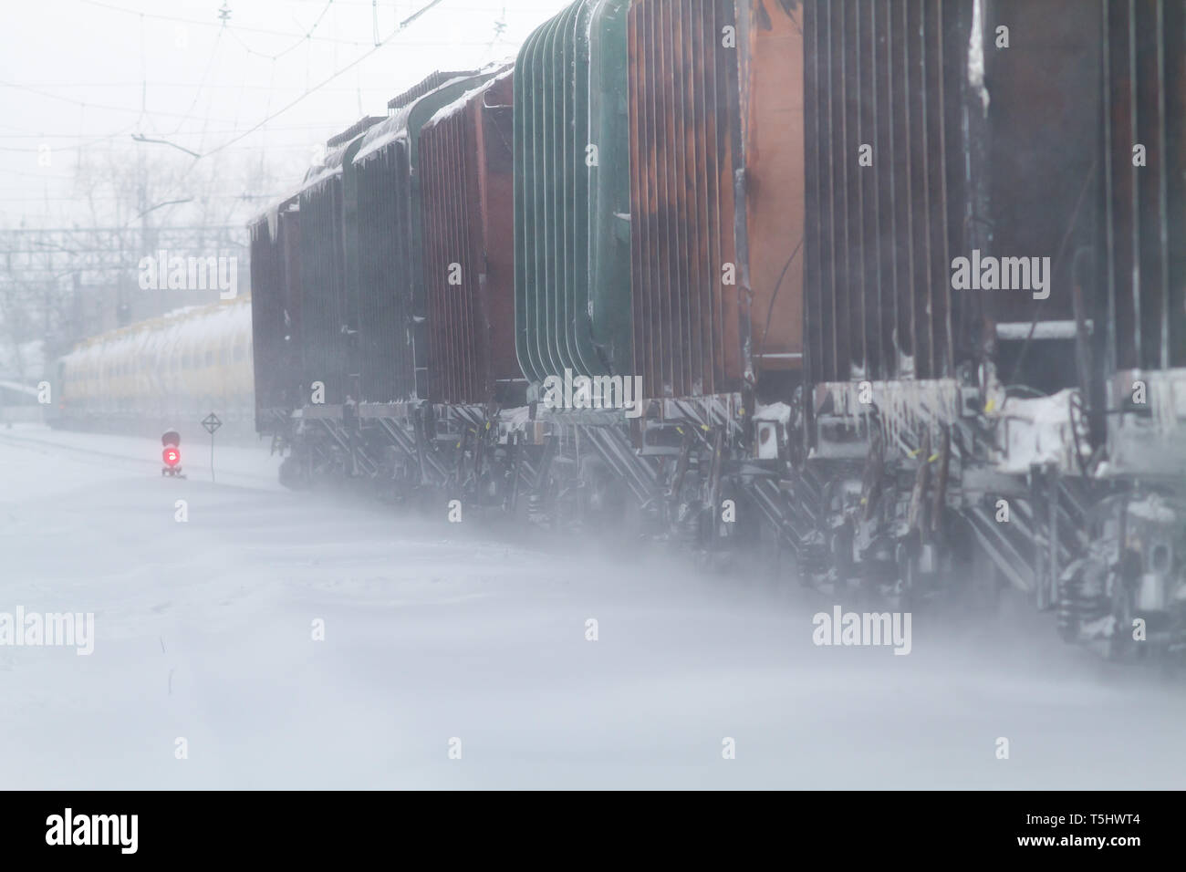 freight cars go by rail in winter in a snowstorm Stock Photo