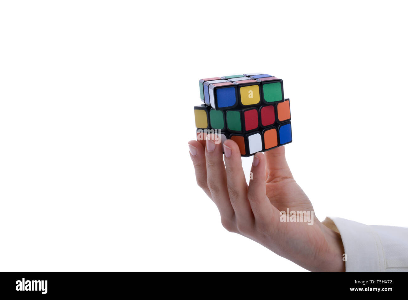 Child holding a Rubik's cube in hand on a white background Stock Photo ...