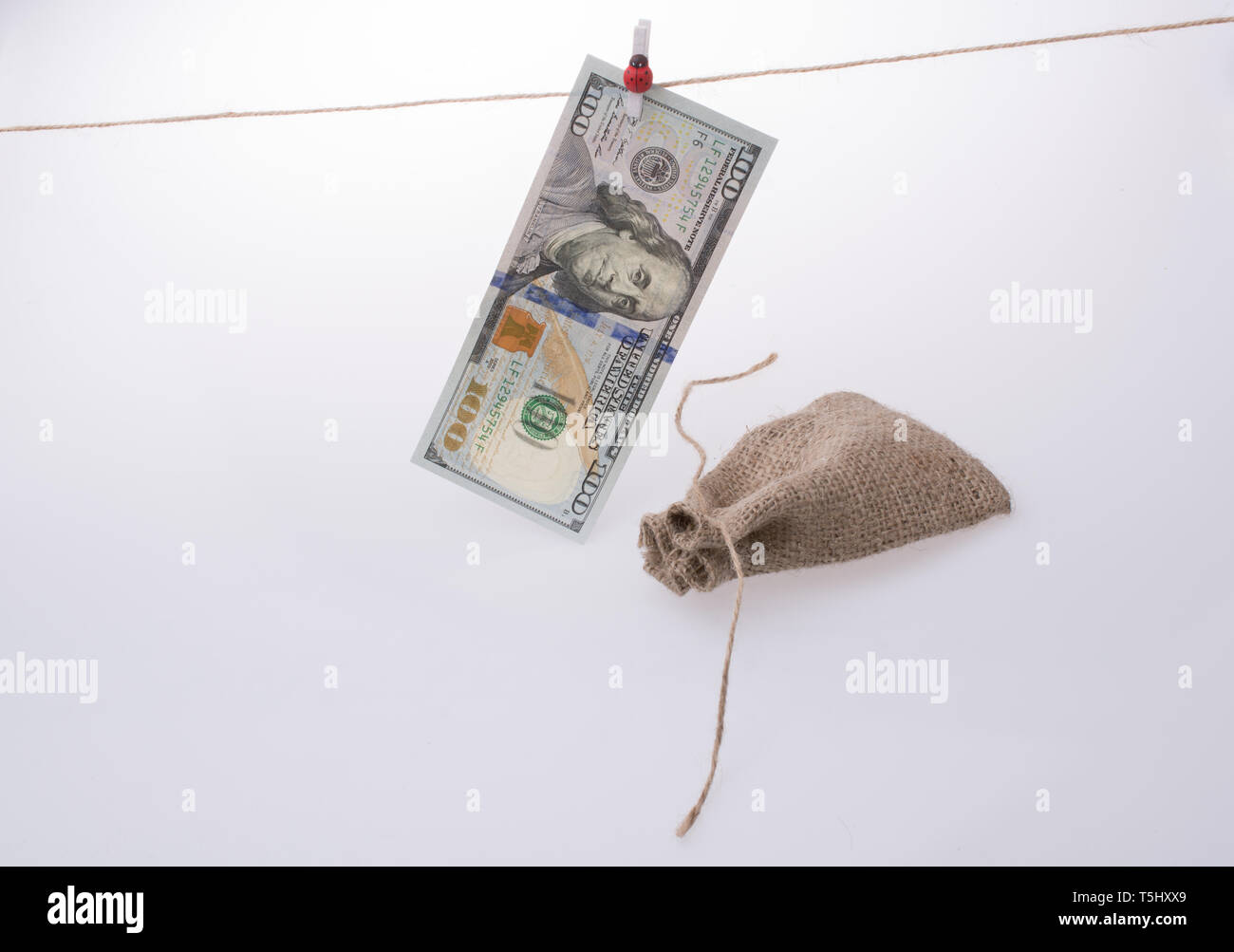 Banknote of US dollar hanging on a linen string Stock Photo - Alamy