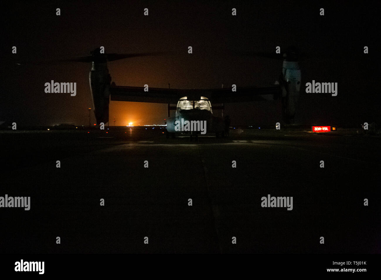 U.S. Marines with Marine Medium Tilt Rotor Squadron 264 (Reinforced), attached to the 22nd Marine Expeditionary Unit, refuel an MV-22 Osprey before an aerial surveillance mission in support of Special Purpose Marine Air Ground Task Force Crisis Response-Central Command operations in Kuwait, April 16, 2019. The SPMAGTF-CR-CC is designed to move with speed and precision to support operations throughout the Middle East. (U.S. Marine Corps photo by Lance Cpl. Mackenzie Binion) Stock Photo