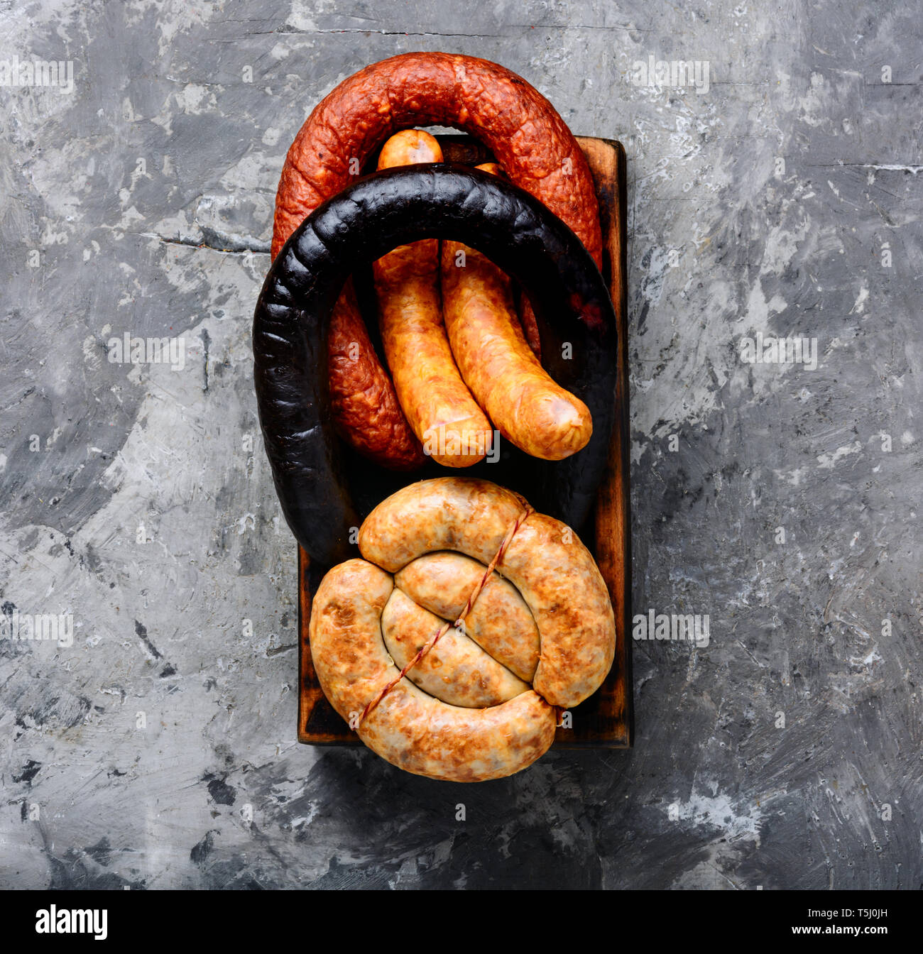 Food tray with delicious sausages and fresh salami.Meat platter Stock