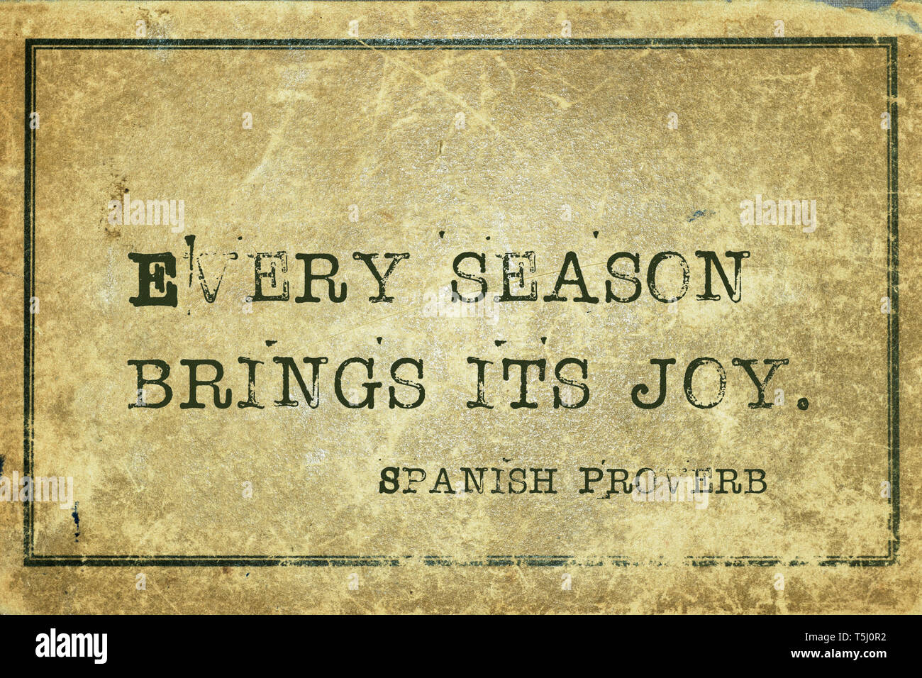 Every season brings its joy - ancient Spanish proverb printed on grunge vintage cardboard Stock Photo