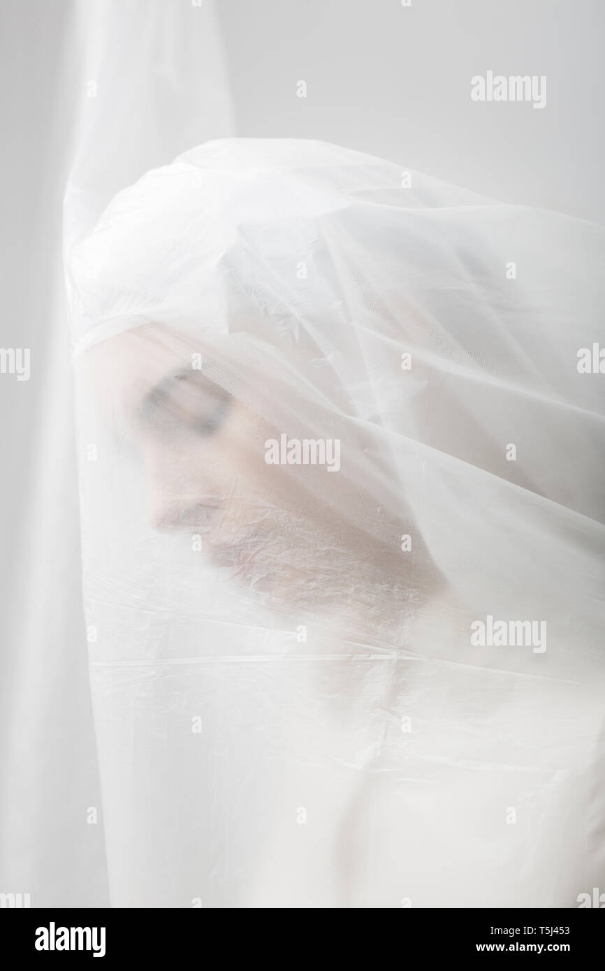 Graceful woman trapped in a veil Stock Photo