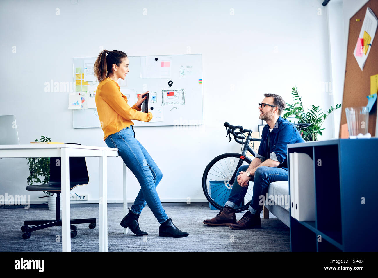 Two colleagues with tablet meeting in office Stock Photo