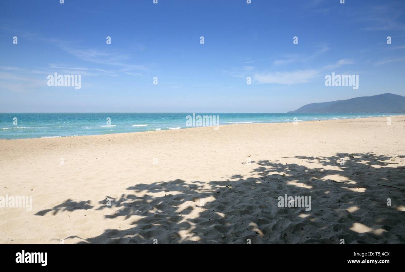 Empty tropical sandy beach, blue sky, shadow of the tree, blue sky, Na Dan Beach in Nakhon Si Thammarat province of Thailand. Stock Photo