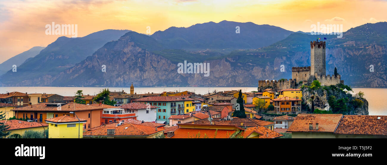 italian village skyline of Malcesine peaceful panoramic town on Garda Lake waterfront romantic horizontal panorama and idyllic picturesque castle Stock Photo