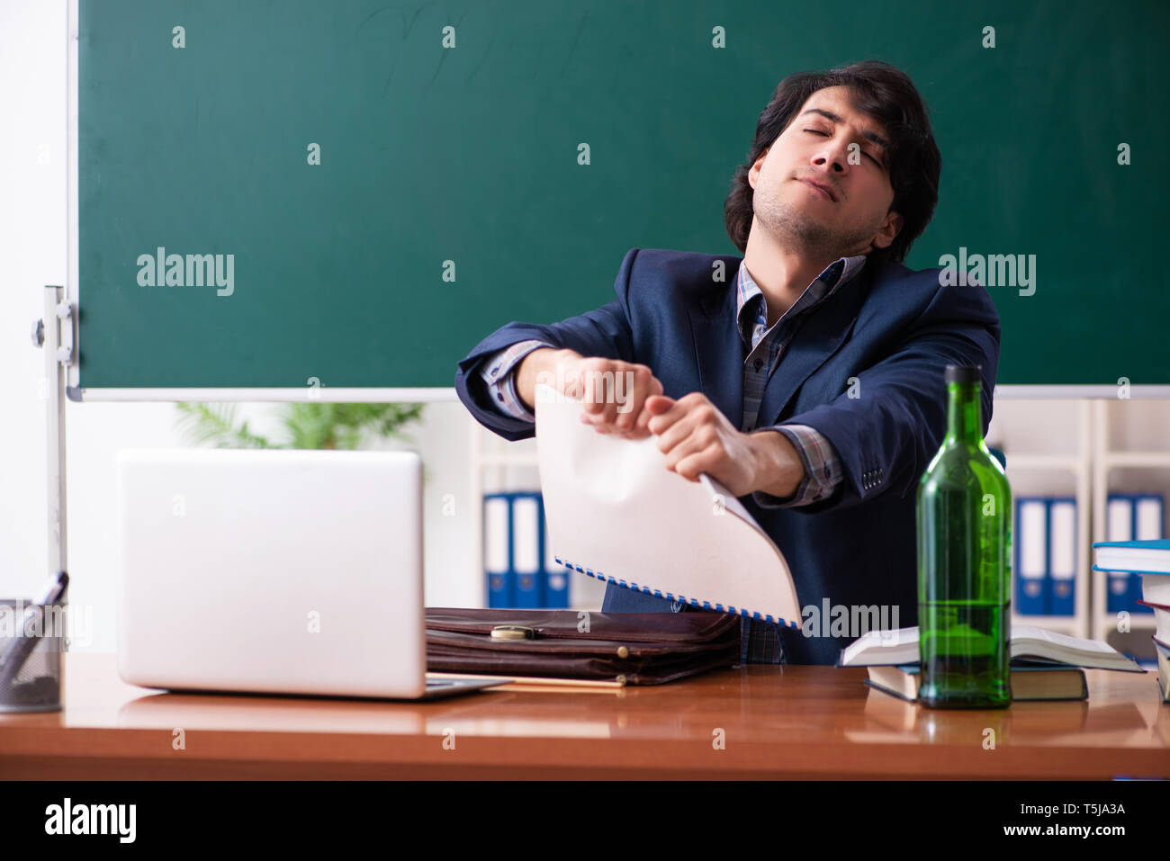 Male teacher drinking in the classroom Stock Photo Alamy