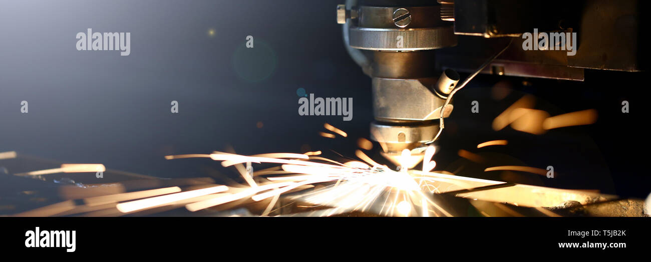 Sparks fly out machine head for metal processing Stock Photo